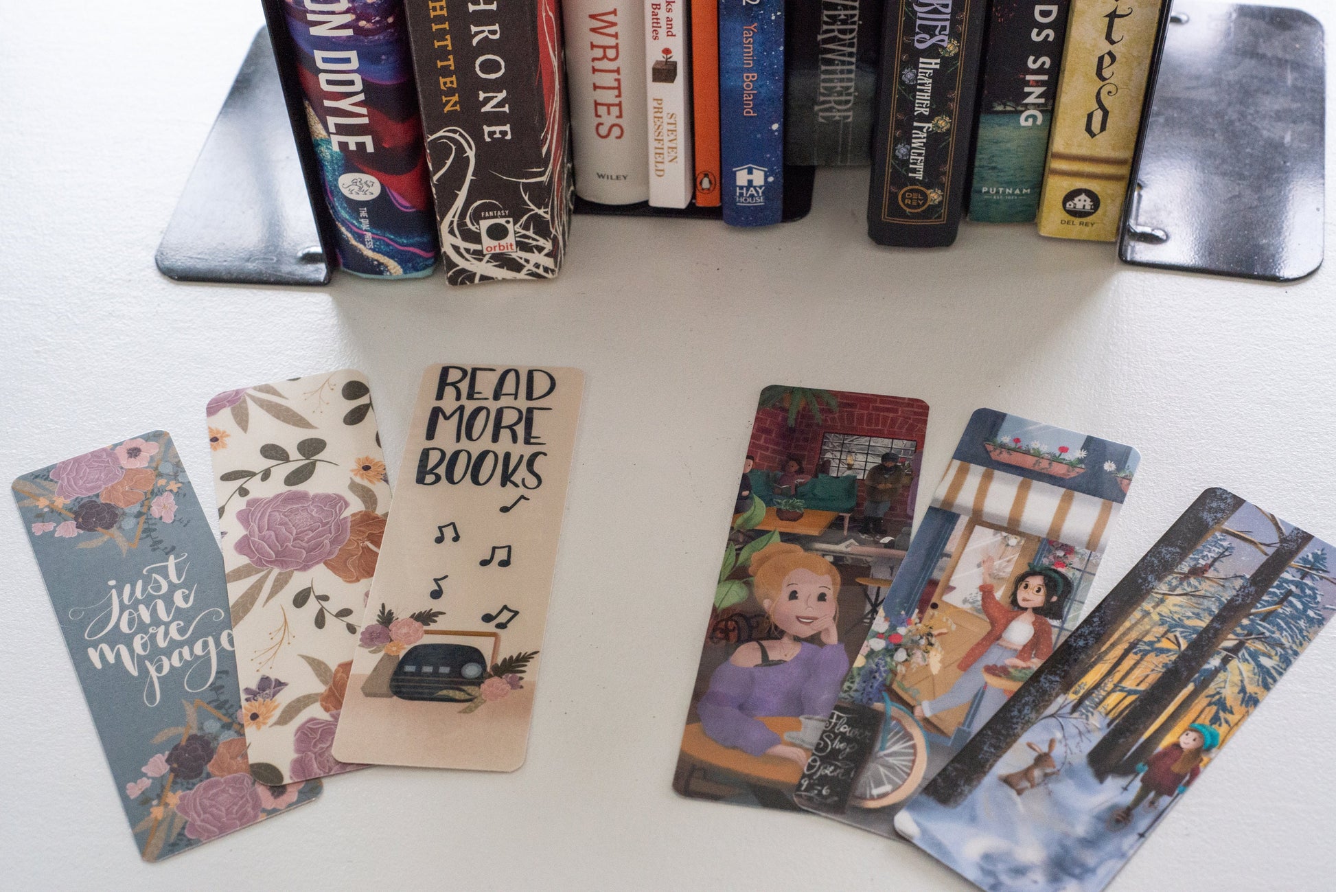Full collection of bookmarks featuring illustrated characters and boho floral designs printed on cardstock and laminated. 