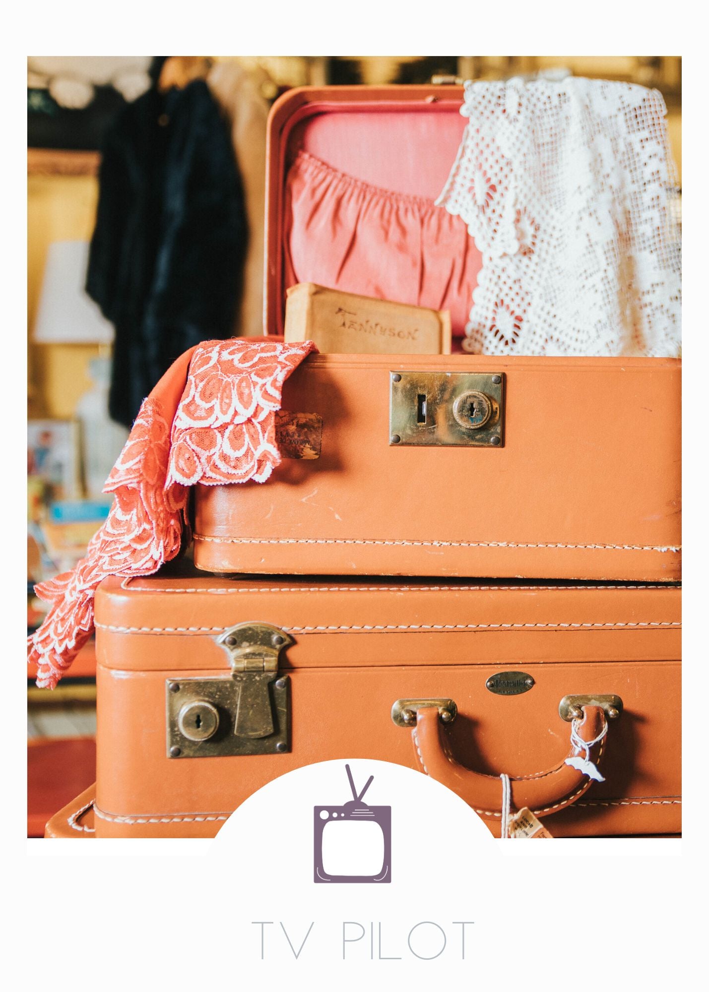 A stack of light brown vintage suitcases with lace trimmed dresses spilling over the side. A reference photo for the TV Pilot screenplay, Simpler Times written by Emily Prescott
